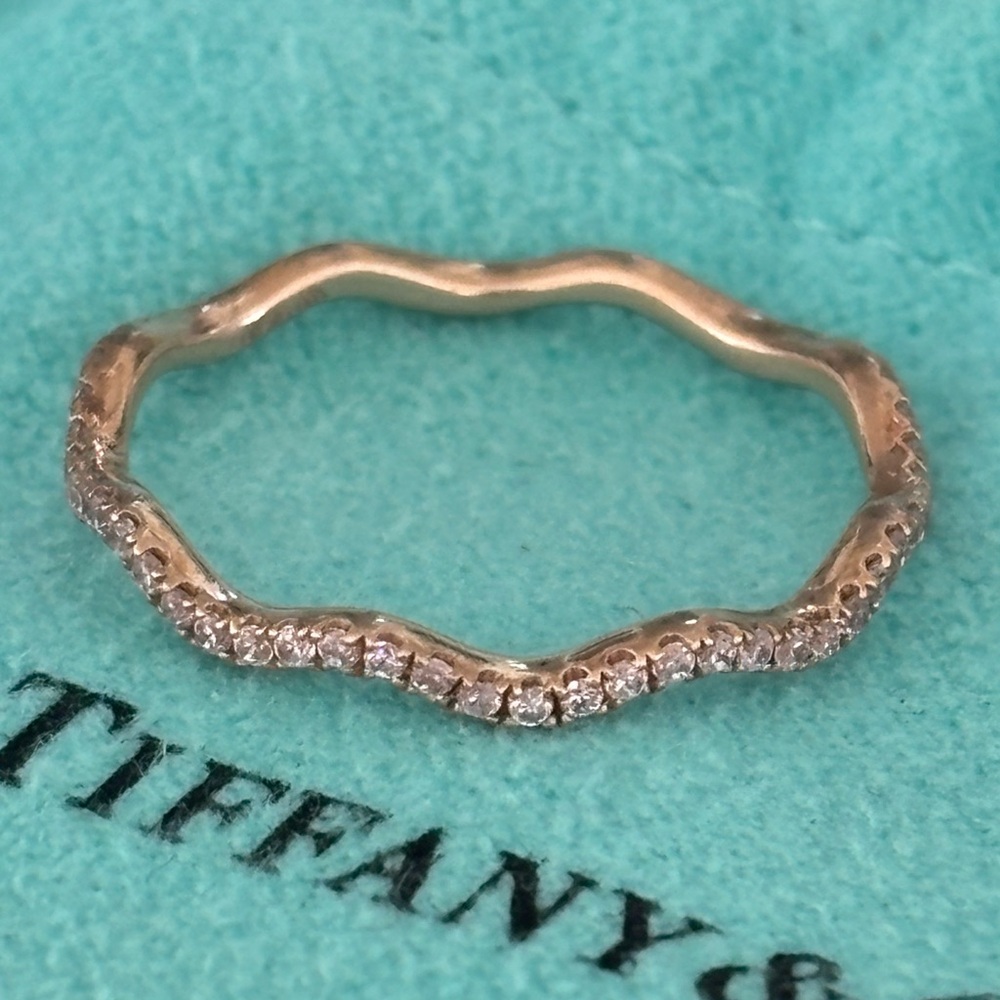 Rose gold band with pink diamonds.